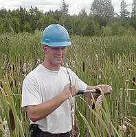 Eric sampling peat in constructed wetlands at the LTV Steel Mining Company site.   The peat will be analyzed for nickel and copper concentrations.