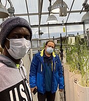 Franklin (left) with advisor Dr. Halis Simsek (right) in the greenhouse.