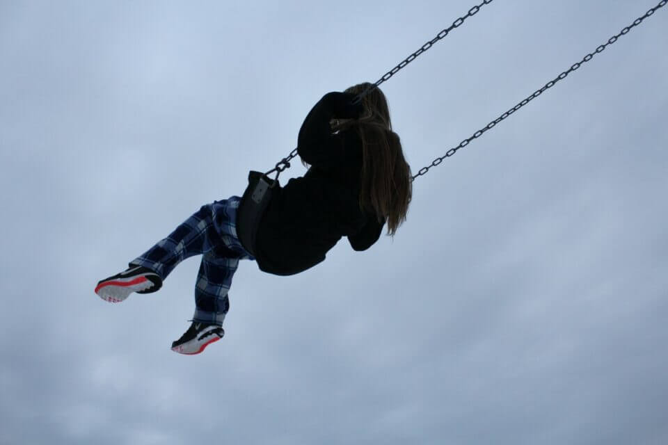 Girl swinging toward the sky